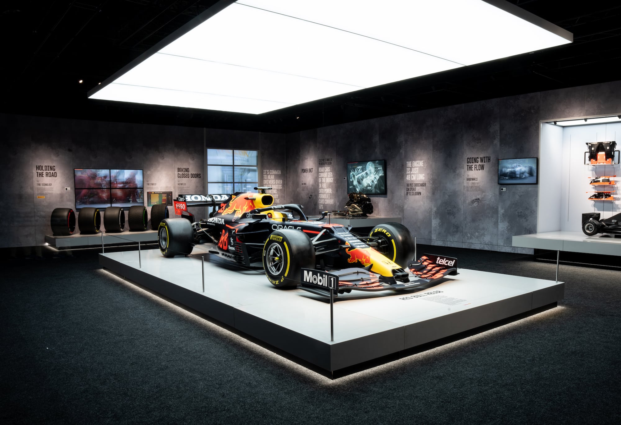 A Red Bull Formula 1 car on display at the Formula 1 exhibition in Amsterdam. The walls of the room highlight different innovations developed by famous Formula 1 teams.