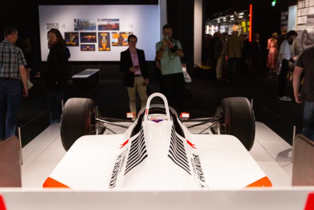 A rear view of a historic white Formula 1 car on display at the F1 exhibition.